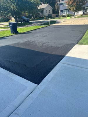 Clean lines with sealcoating next to newly poured concrete