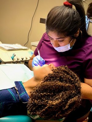 Dental assistant Ana performs orthodontic treatment of fast braces patient.