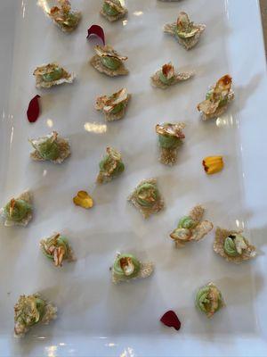 Bites of seafood rice crackers with guacamole butter and mini crispy Monterey bay shrimps carpaccio