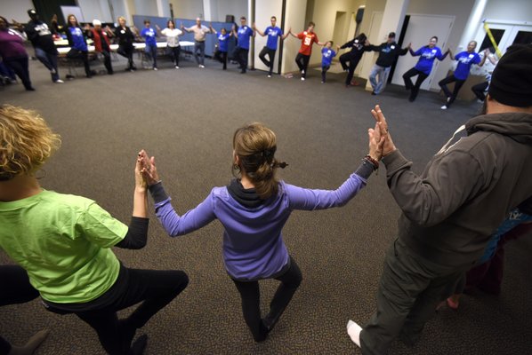 Families are lead through a light yoga practice at our annual Winter Retreat.