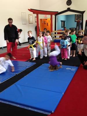 Sensei Lincoln working with the children on shoulder rolls.