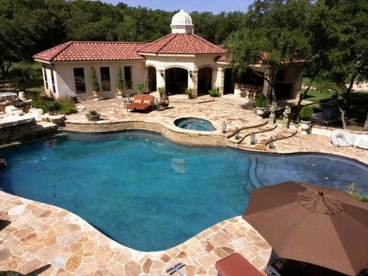 Pool house created for outdoor living.   Includes a full kitchen, guest quarters & TV area