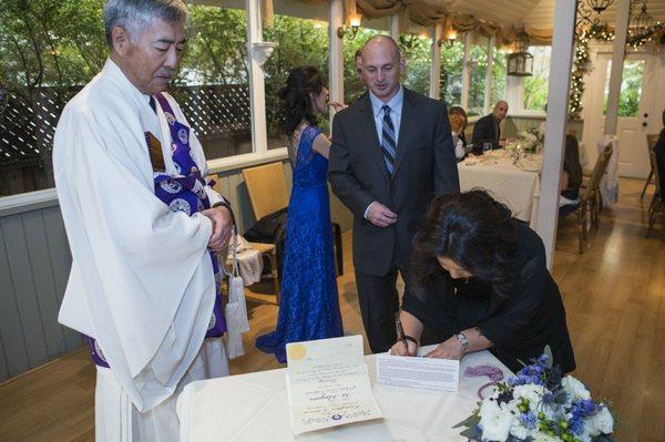 Bob perfectly caught me cramming food in my mouth as my sister signs our license. I was starving!