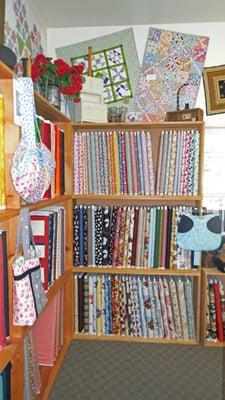 The top shelf here holds the remaining pieces of my '30's line of fabric! Speckled Hen Quilts has lots of chicken fabric, too!