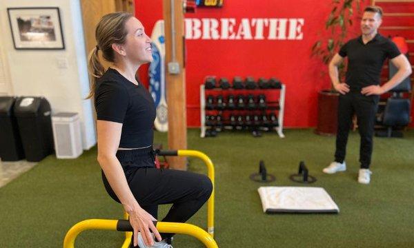 A personal training client working out with Tiger Ford, owner of The Fix Gym