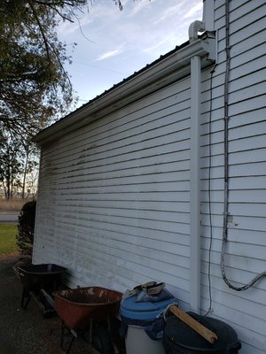 Installed gutters with downspouts.