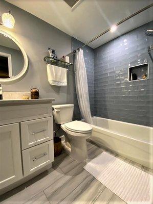 Newly renovated hall bath in Vienna townhouse, with updated tub surround, new floors, and Bertch cabinetry vanity