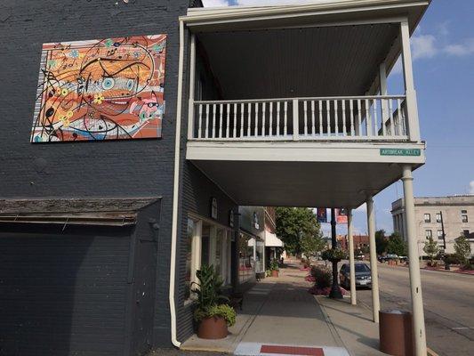 The Piano Works with Mural by artist, Roger J. Williams, on side near front door!