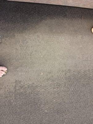 Worn out carpeting by the cashier - this store has seen better days.