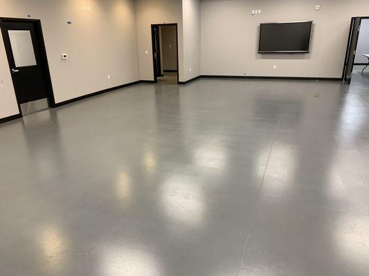 City of Monroe emergency center training room ground, stained, and sealed concrete floor.