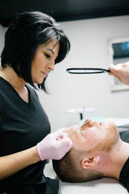 Measuring the brows at DFW Microblading.