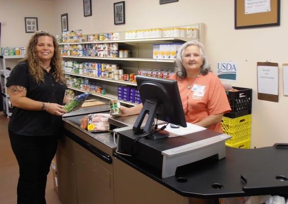 Staff member and volunteer in House of Hope's food pantry in Hobe Sound.