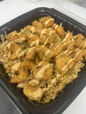 Fried Shrimp platter on a bed of Jambalaya with a drizzle of our Cajun Ray's sauce