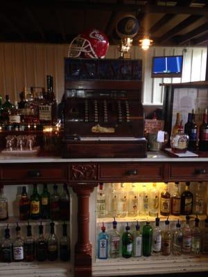 Huge antique cash register behind bar