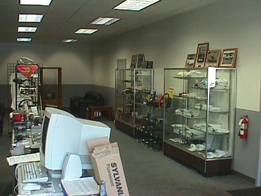 A look at the display cabinets in our showroom, full of Porsche t-shirts, hats, key fobs, decals & models.