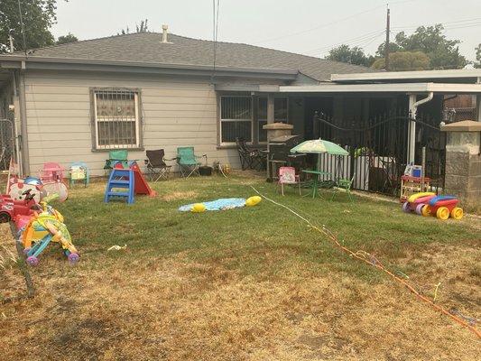 The front yard w/toys & play structures for the Childcare