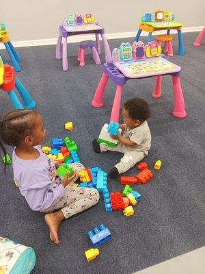 Our 7 month old Kei'Von is enjoying play time with his blocks, A'Miera-Bleu is assisting.