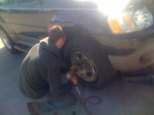 Helping with a flat tire on a Sunday afternoon.