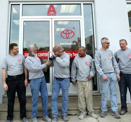 The team at Paul Bros. Auto body having some time to chat out front during a photo shoot.