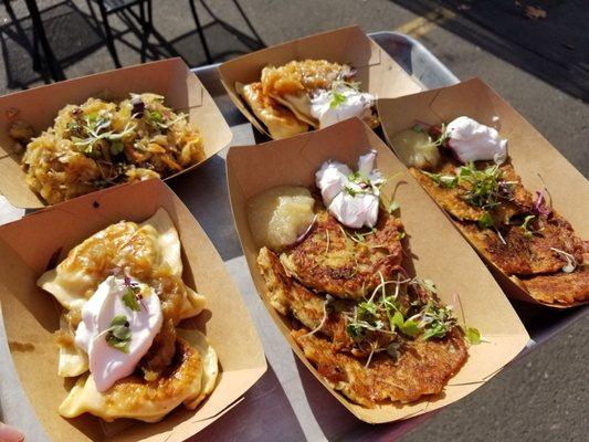 Pierogi, potato pancake, and side of cabbage