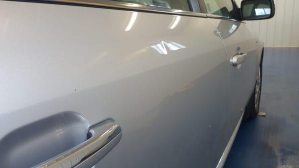 Before and After on a small dent on a Ford Taurus.