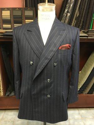 A double-breasted blue with chalk stripes suit finished.