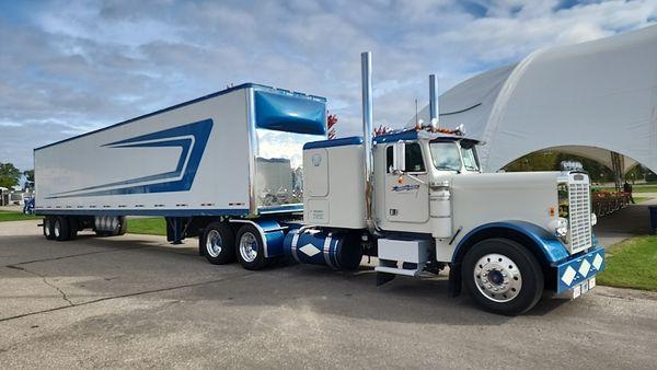 Gorgeous semi truck and trailer at the fair.