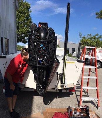 Our technician working on a new Mercury Marine V-8 Outboard.