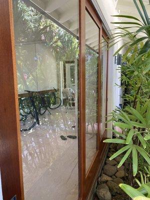 AFTER: African mahogany sliding doors restored, screen removed and glass installed, so beautiful!