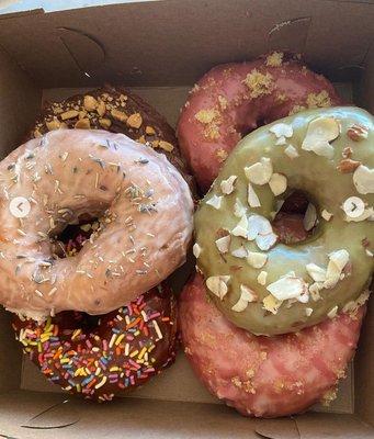 Donuts are (from bottom left) Turtle, chocolate sprinkles, Lavender, (bottom right)Berry Hibiscus, strawberry lemonade, and matcha almond.