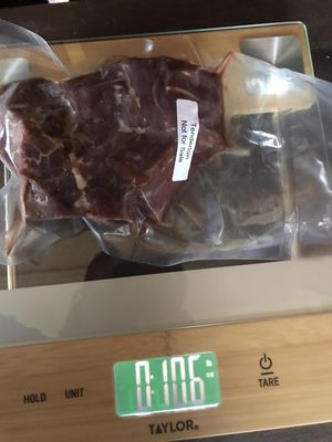 Actual packaging and weight of a cut of meat. The 0 is pounds and the right side number is ounces. A pound is 16 ounces.