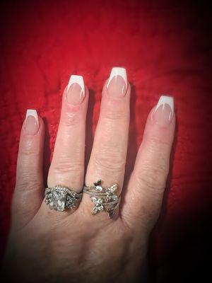 A full set of acrylic nails with a French tip