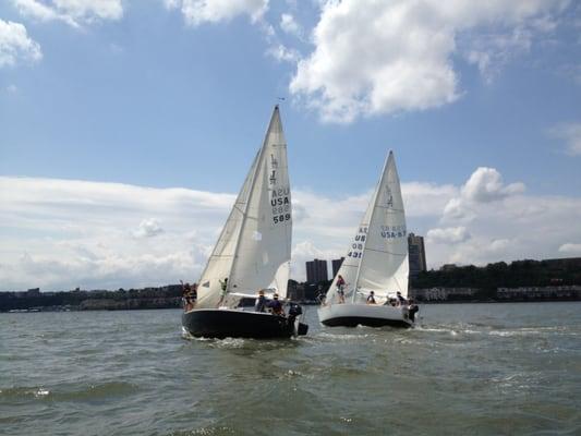 Camp boats sail hard towards downtown during a normal day of camp.