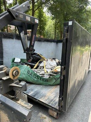 Setting the Bagster in the dumpster.