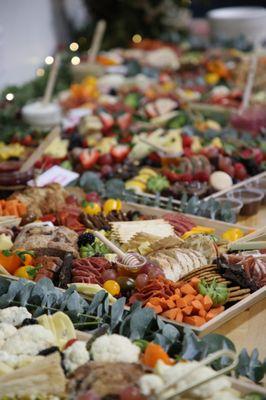 Grazing table charcuterie boards for a holiday event. Staging included greenery and mason jars for an elegant event.