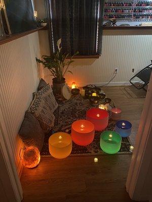 Crystal and Tibetan Singing set in ambient lighting for sound bath session.