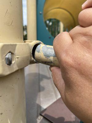 Outdated, rusted, broken playground. Potential danger for children and parents.