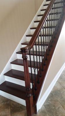 Installation of railing system, treads and painted risers and oak knee wall cap.