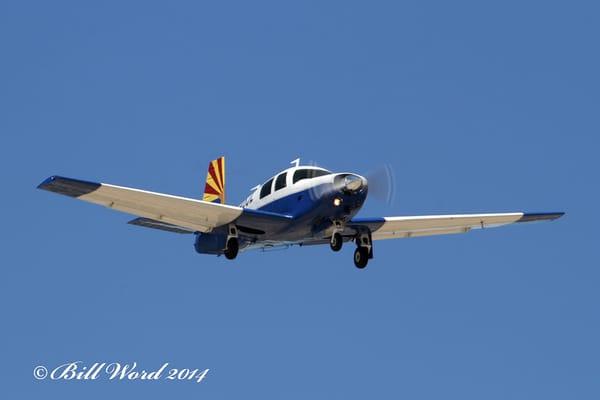 The Mooney, with the iconic Arizona flag paint job, in flight