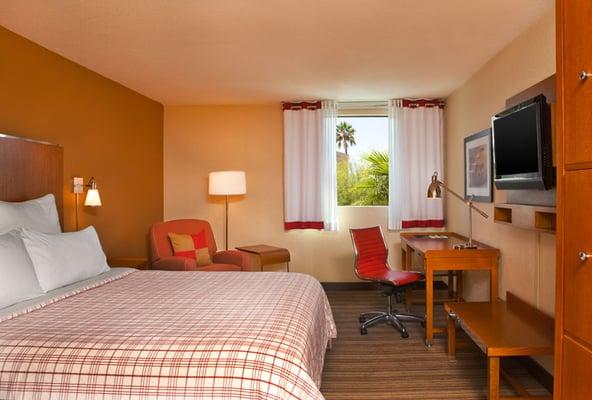 Rooms feature comfortable beds, spacious work areas, ergonomic desk chairs, and 32-inch LCD flat screen TVs.