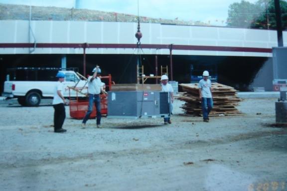 Commercial Roof Top Unit Being Crane Lifted At Strip Mall.