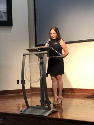 Dori Gerstein, partner, speaking at a conference with other lawyers.