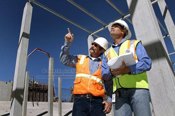 Industrial photography: Engineers reviewing progress in the construction of a Tucson Water water recharge basin in Avra Valley.