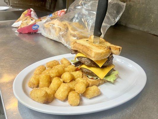 Double cheese burger on texas toast and tots