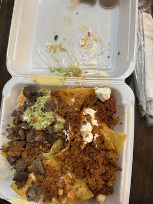 Nacho with finger smeared through the sour cream and guacamole that we asked for none of.