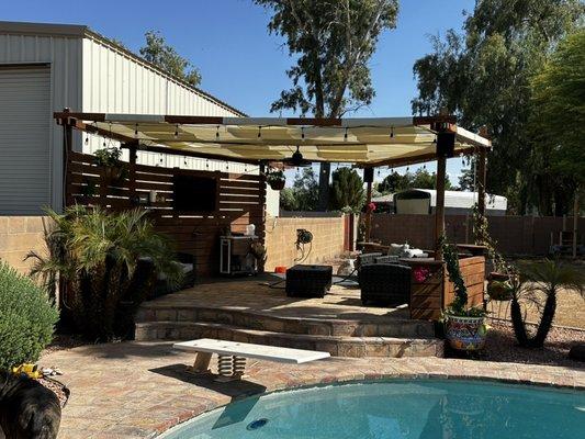 Covered pool patio with misters lights fan speakers and tv