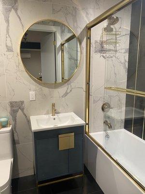 Golden mirror mounted on tile bathroom wall! She loved it!