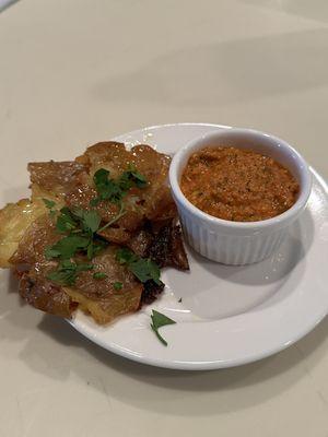 Crispy smashed potatoes with Romesco sauce