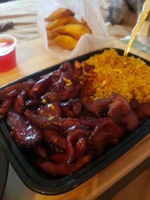 Boneless spare ribs with pork fried rice combo. Also comes with wonton soup and an egg roll. In the background are krab rangoon.