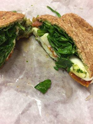 Egg white Caprese sandwich - pesto, roasted tomatoes, spinach, fresh mozzarella, egg whites, on a skinny wheat roll